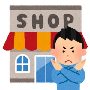 お店の前でバツをする男性